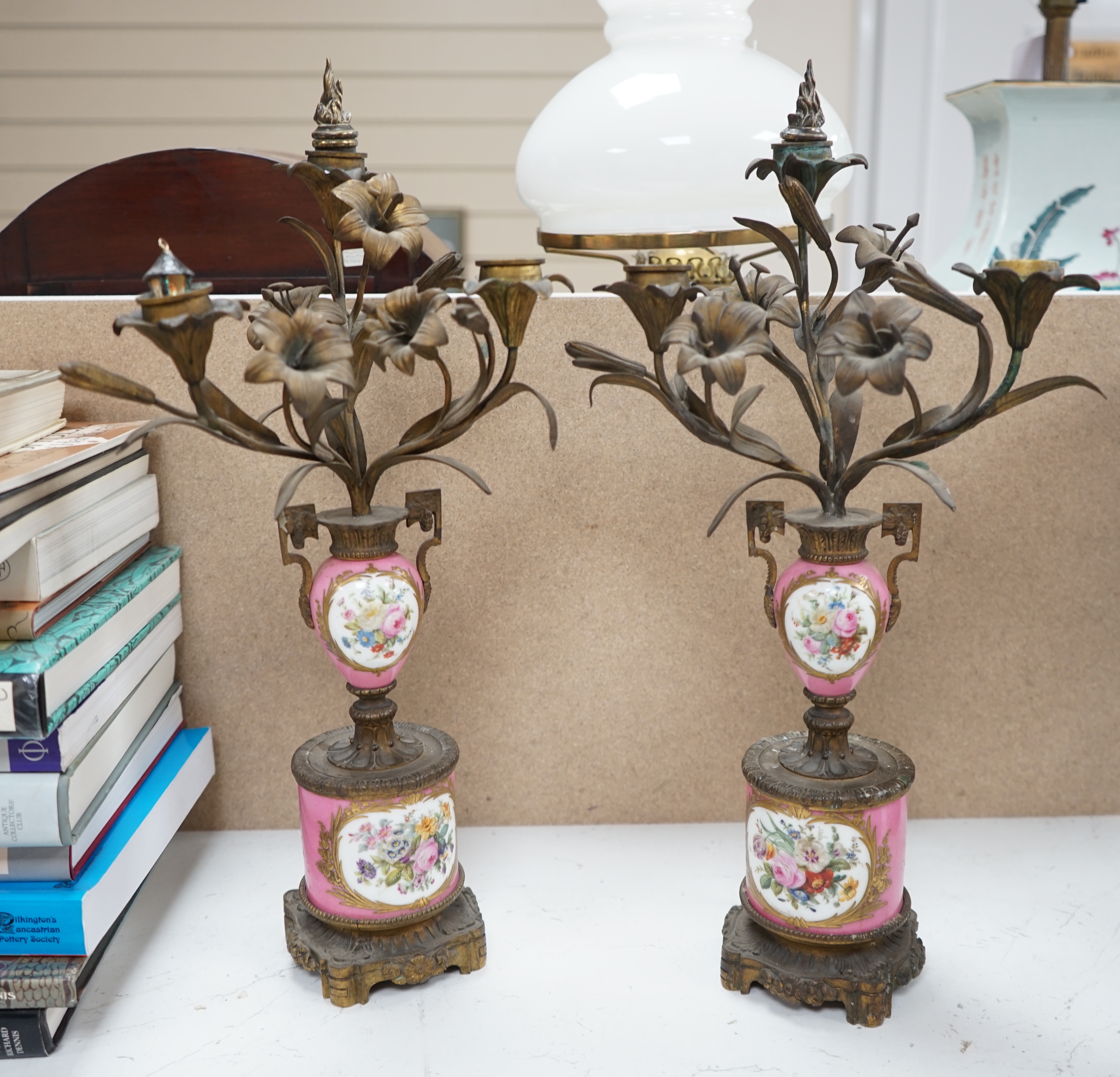 A pair of French porcelain mounted gilt metal candelabra and one other pair, tallest 45cm. Condition - fair